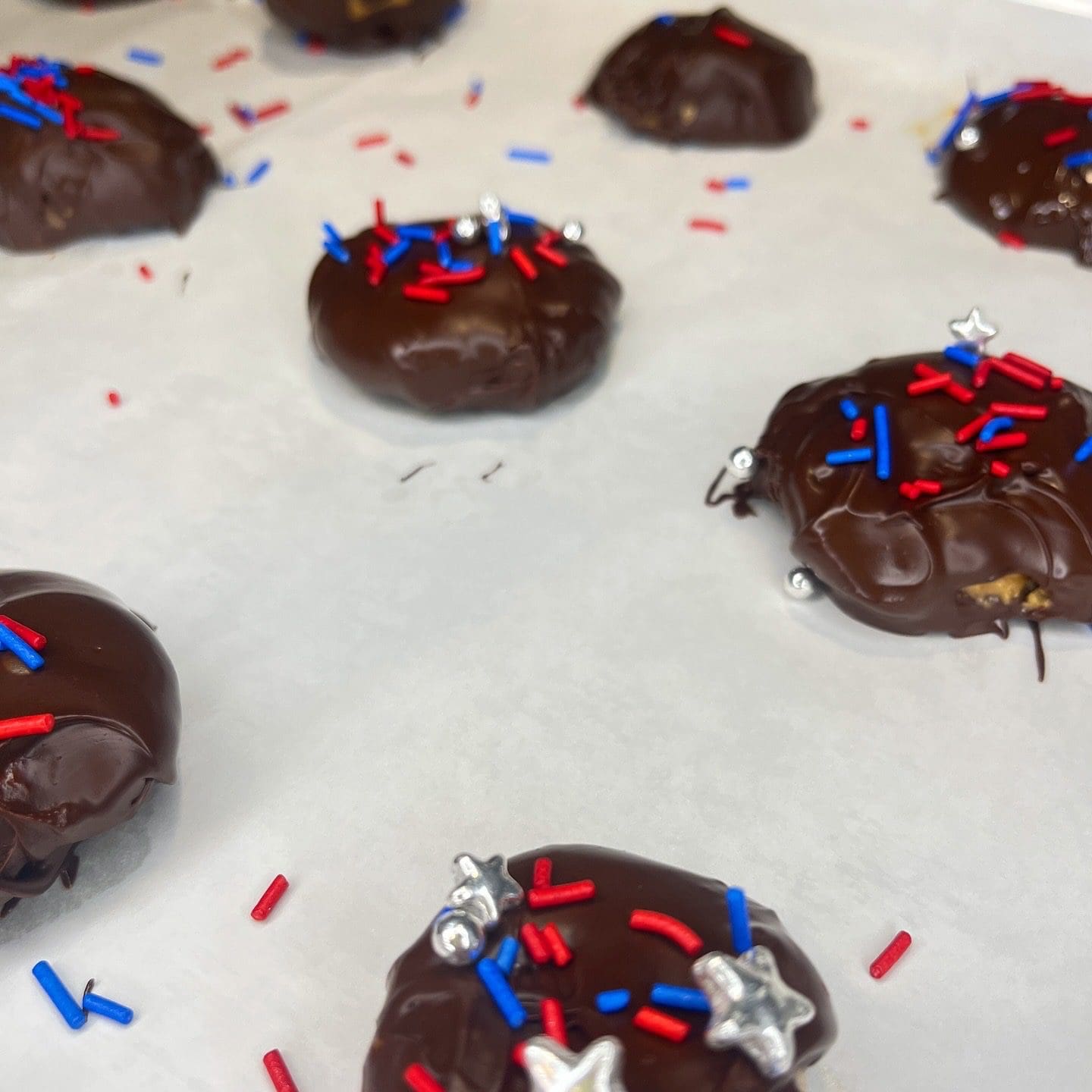 Chocolate cookies with red and blue sprinkles.