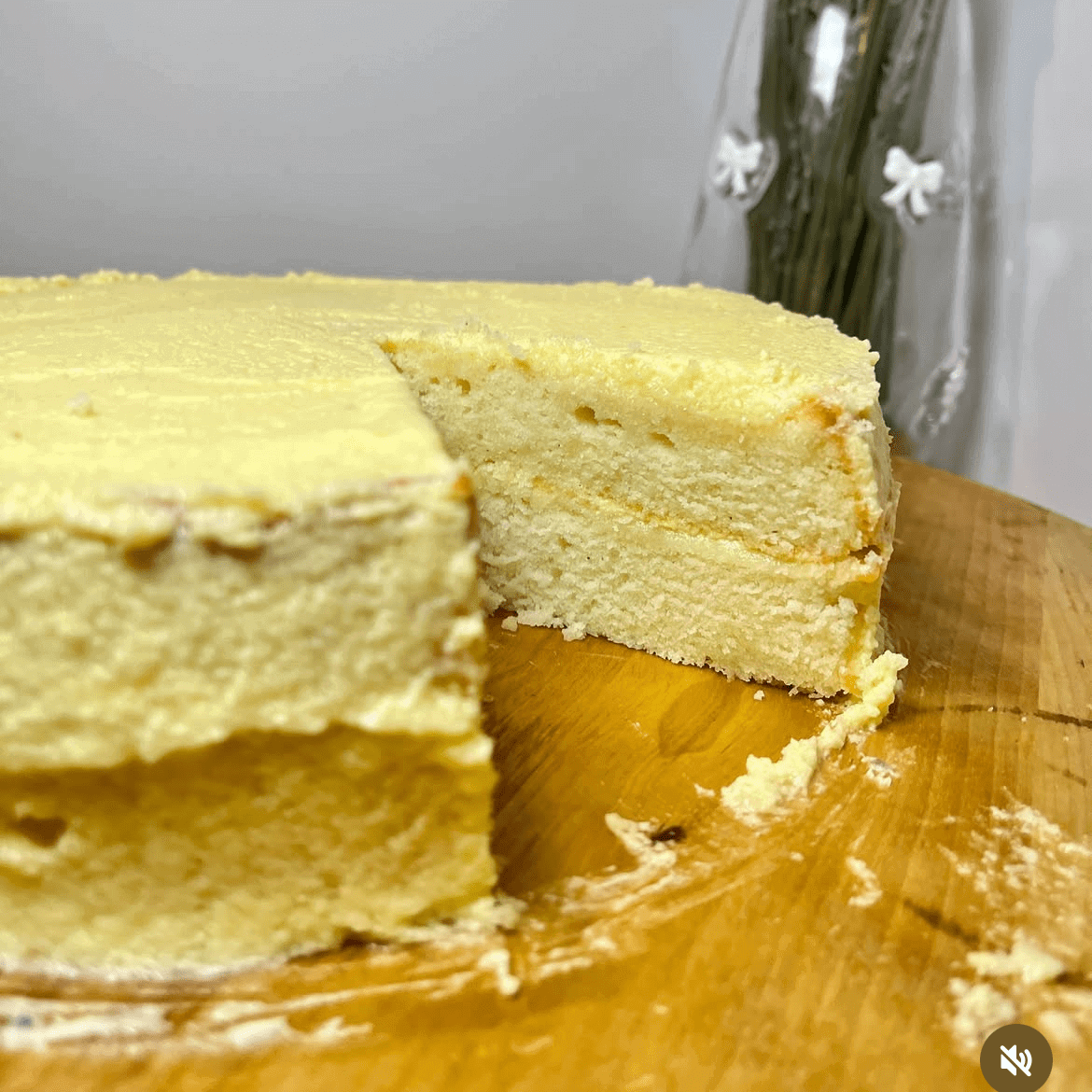 Yellow cake with slice removed on board.