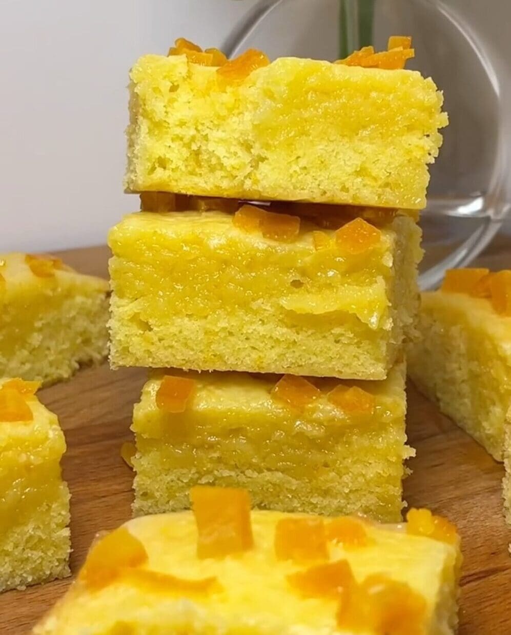 Yellow cake squares with orange toppings.