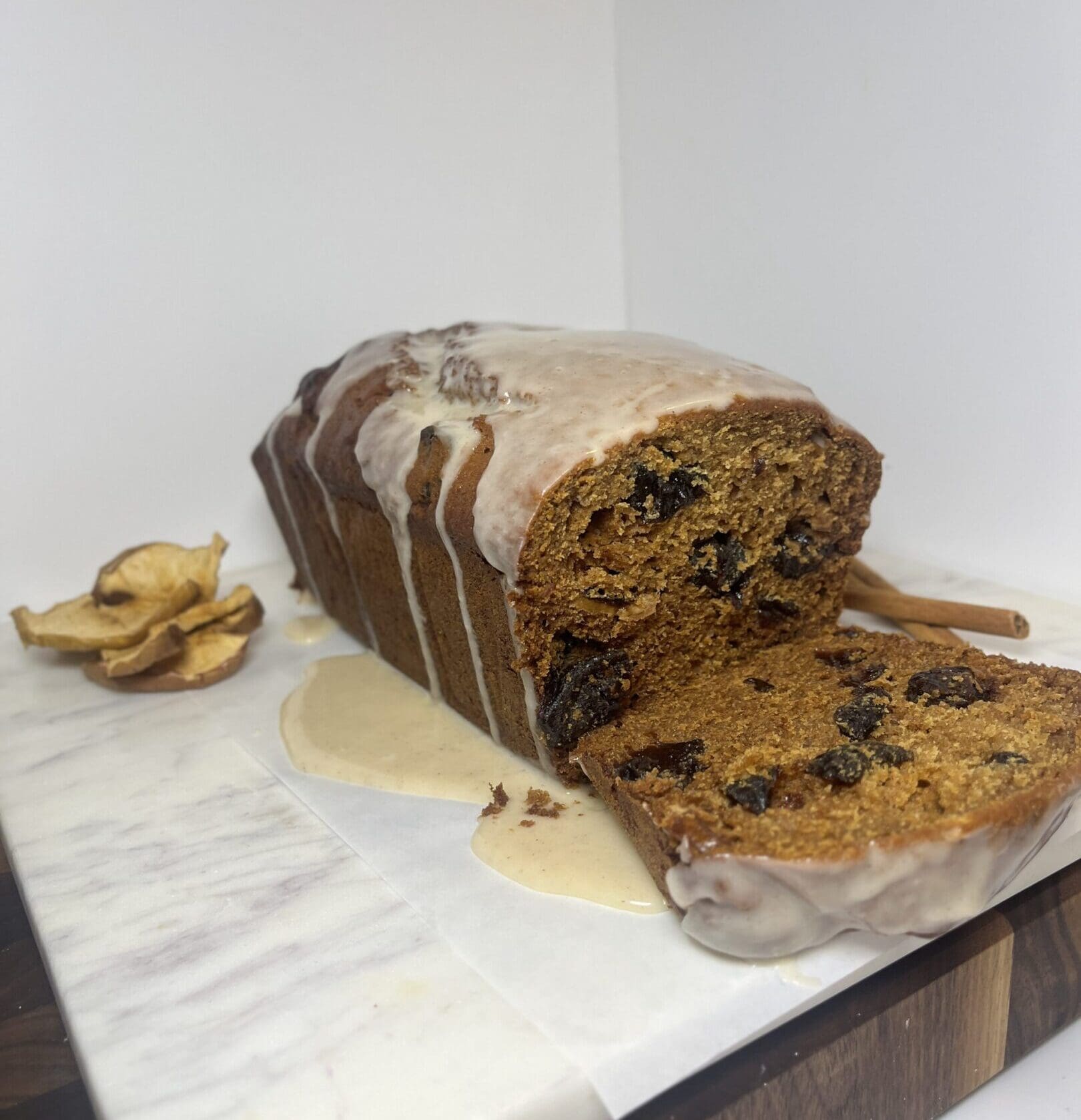 Iced fruit loaf on marble slab.
