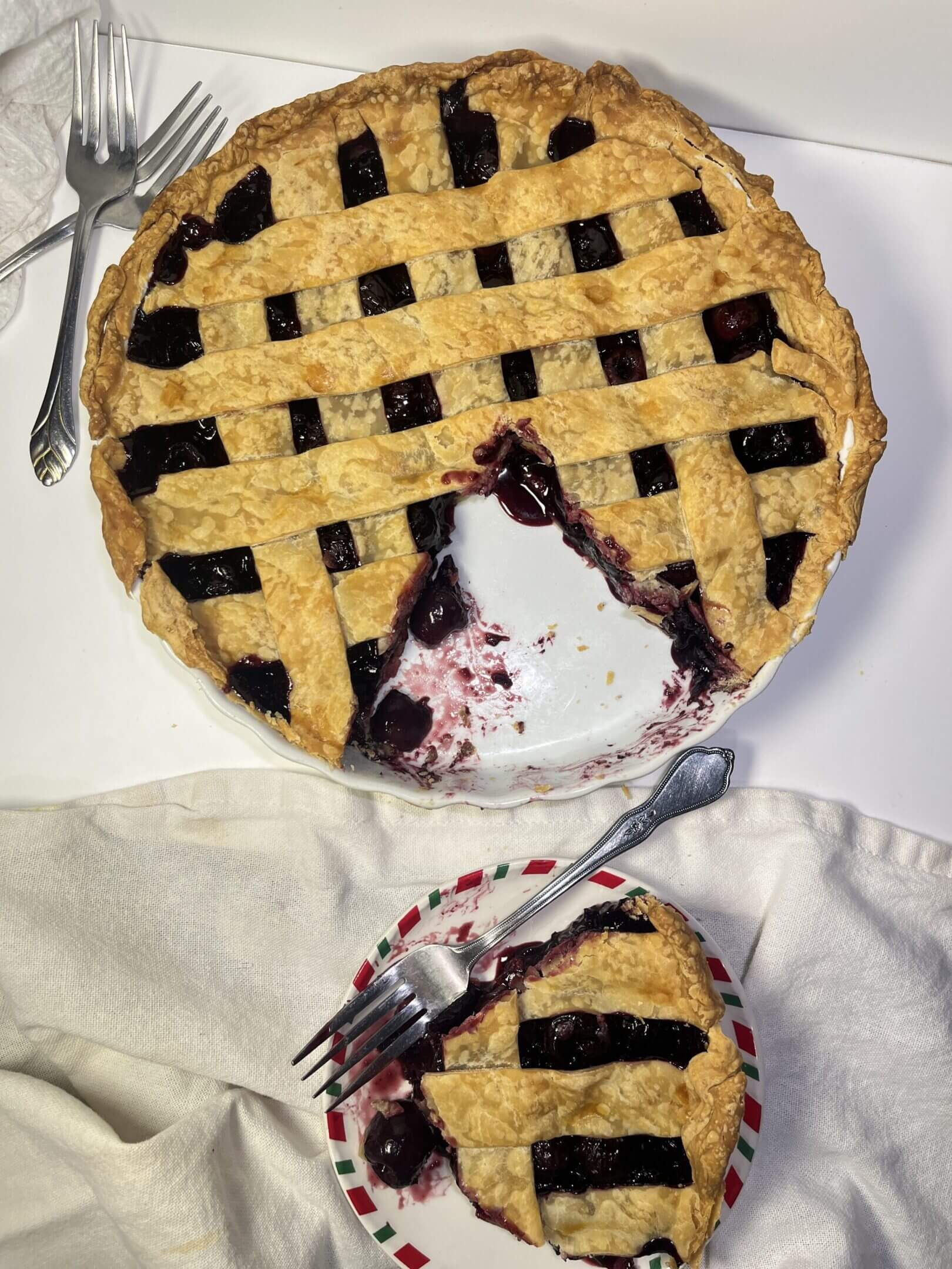Cherry pie with lattice crust and slice.
