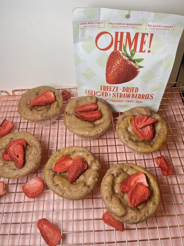 Cookies topped with freeze-dried strawberries on rack.