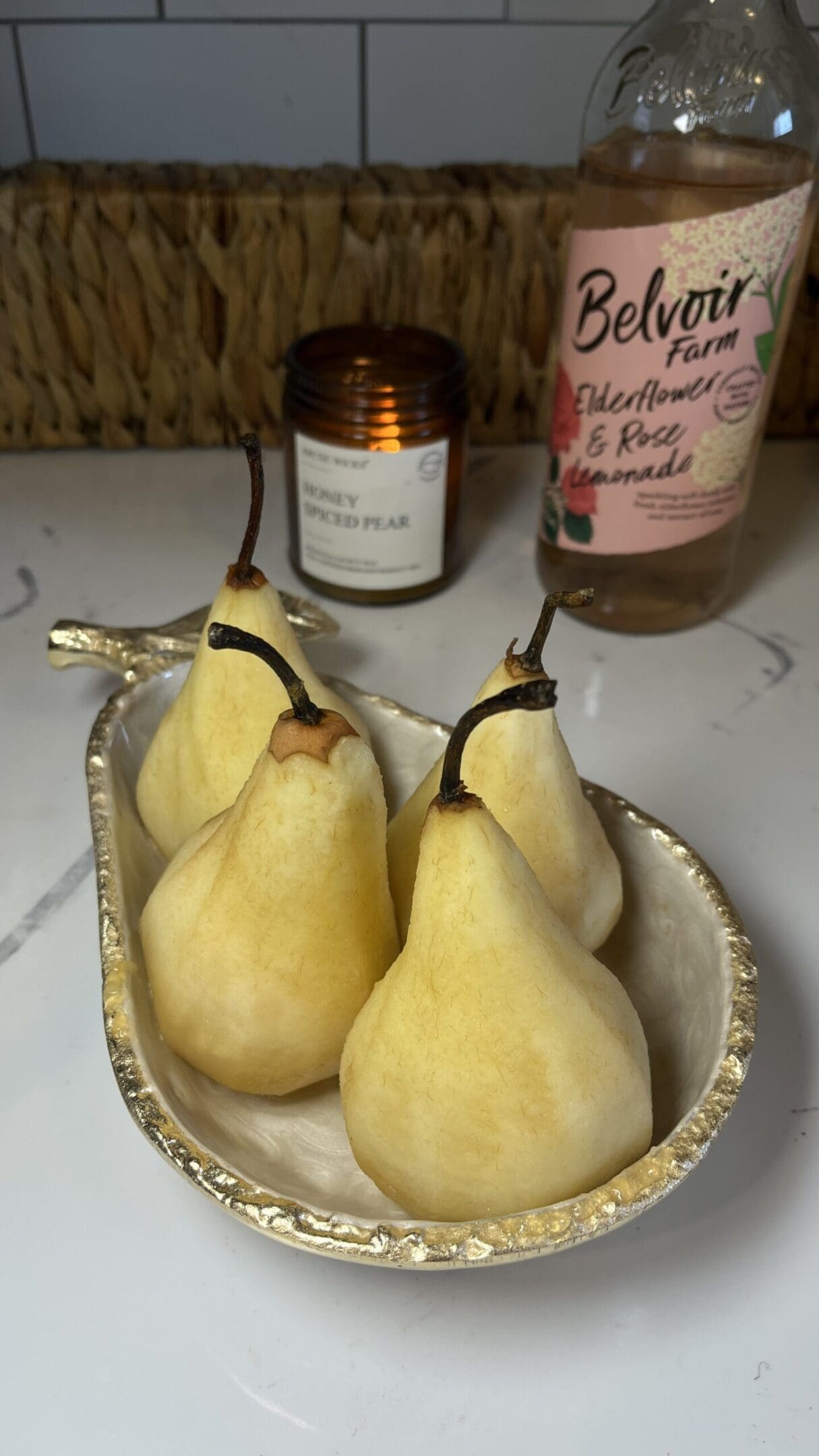 Pears in a decorative dish on counter.
