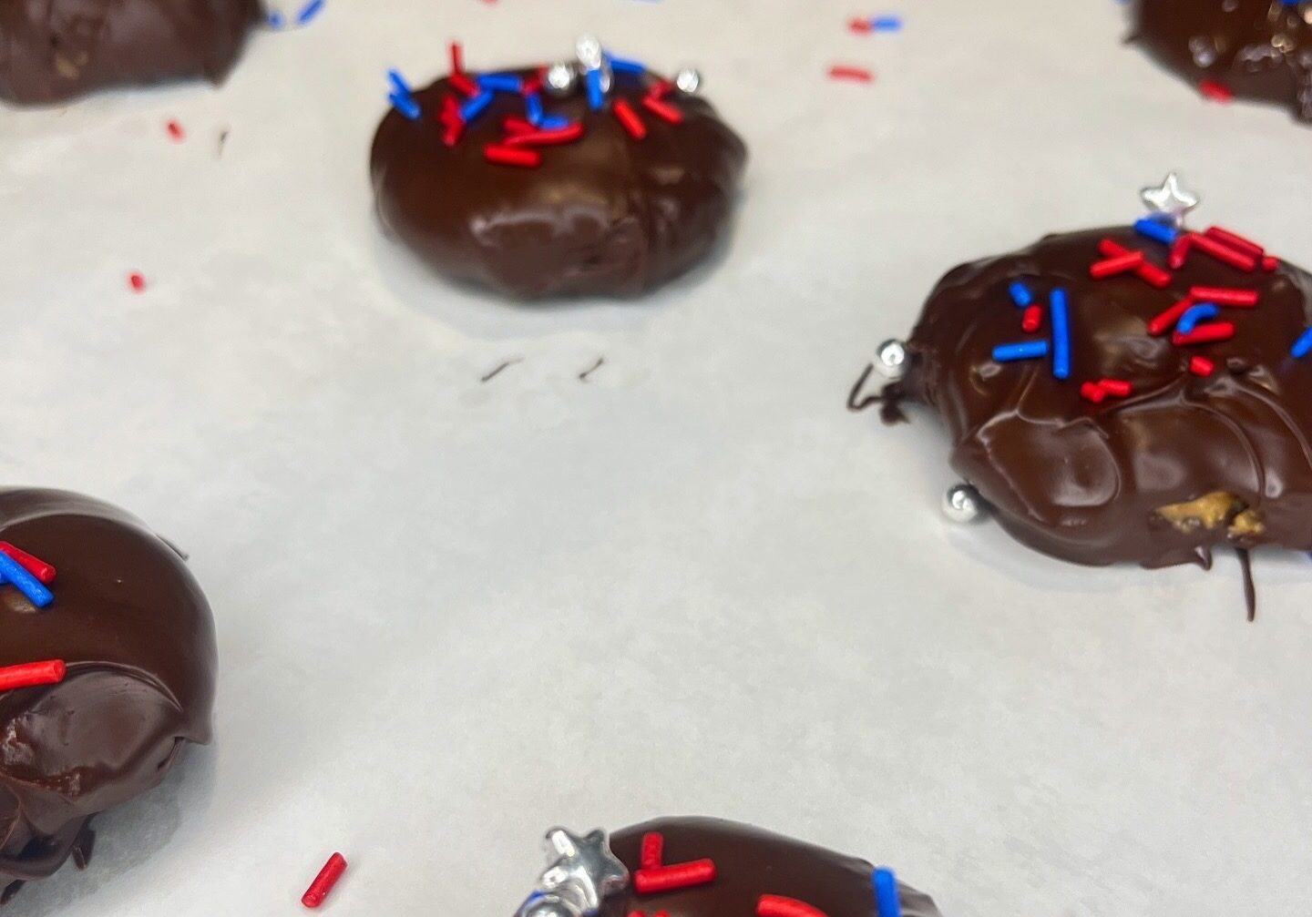 Chocolate cookies with red and blue sprinkles.