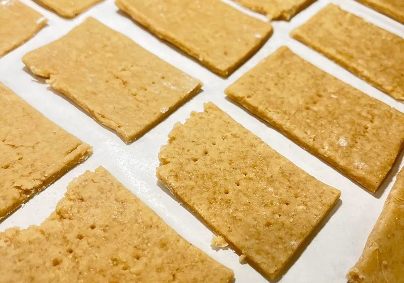 Rows of rectangular crackers on a flat surface.