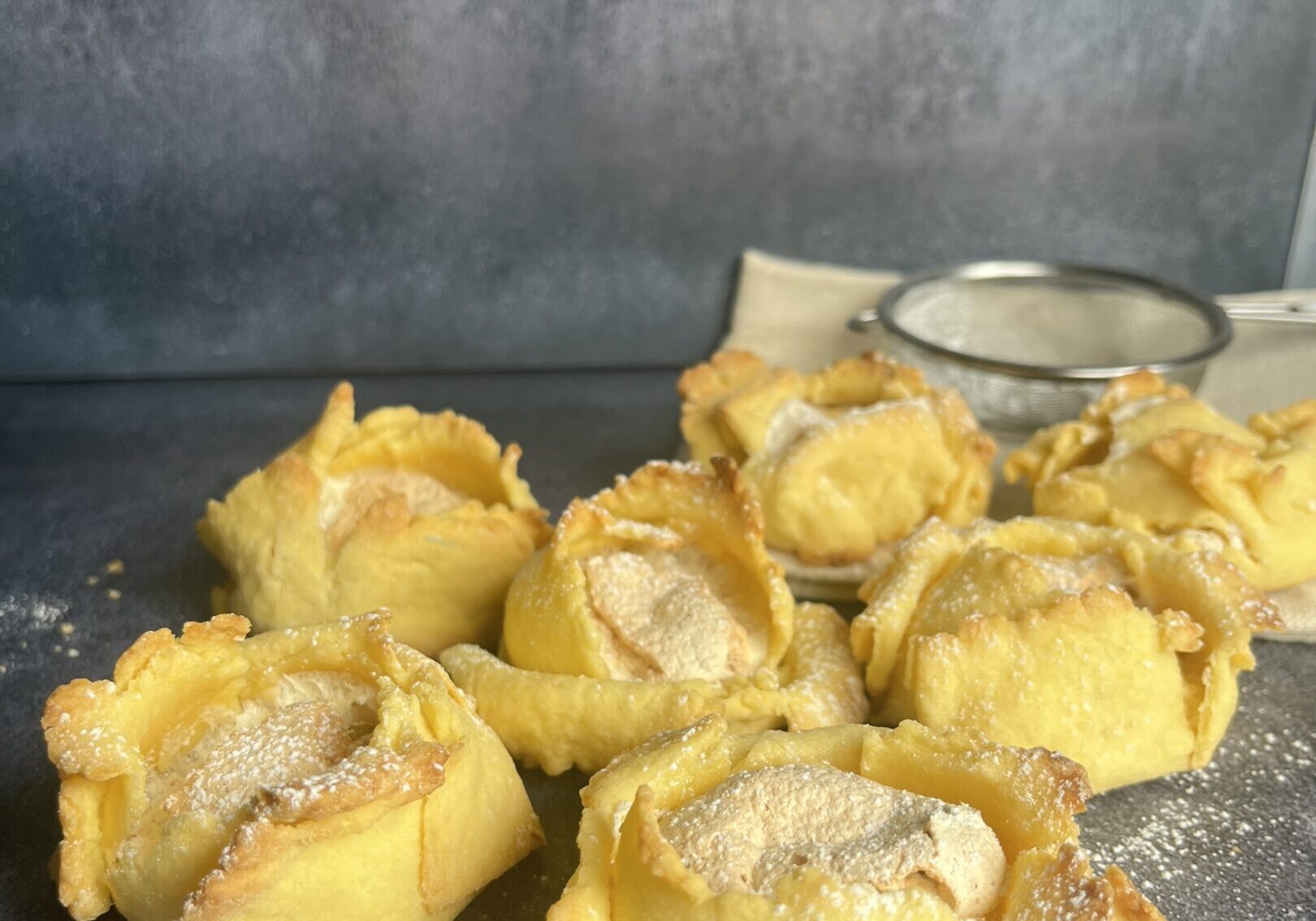 Pastries arranged on a dark surface.