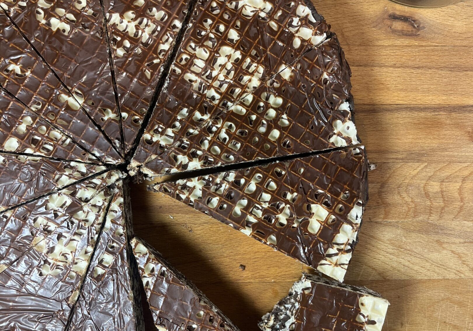 Chocolate-covered rice cakes on wooden table.
