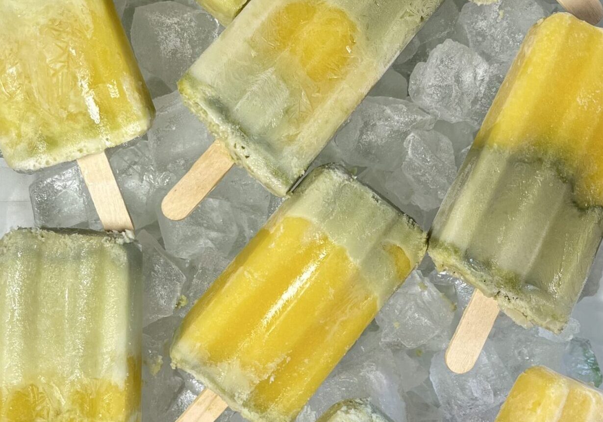 Yellow and green popsicles on ice.