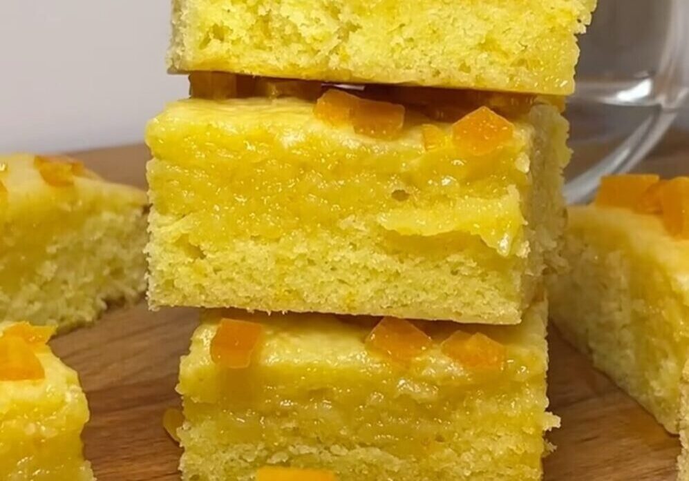 Yellow cake squares with orange toppings.