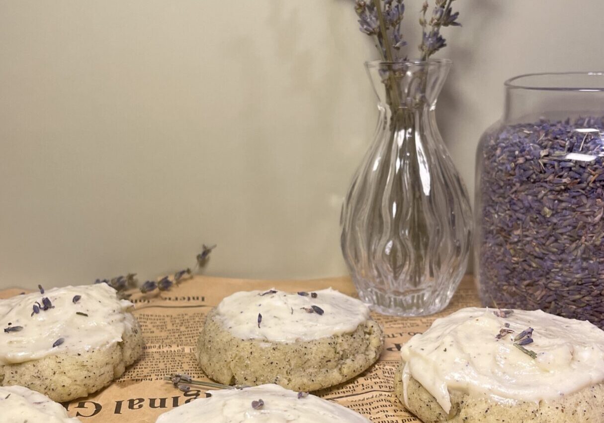 Lavender cookies with icing on newspaper background.