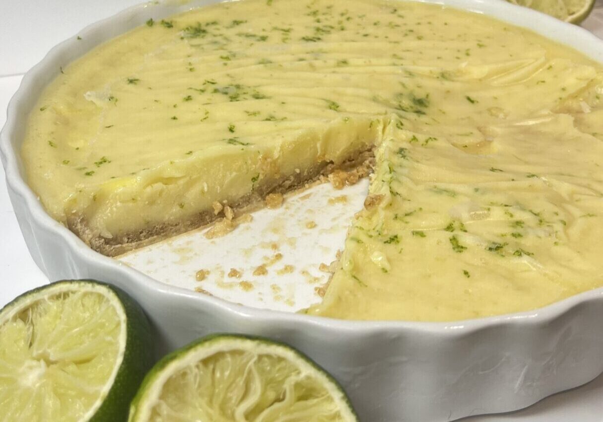 Key lime pie with fresh limes nearby.