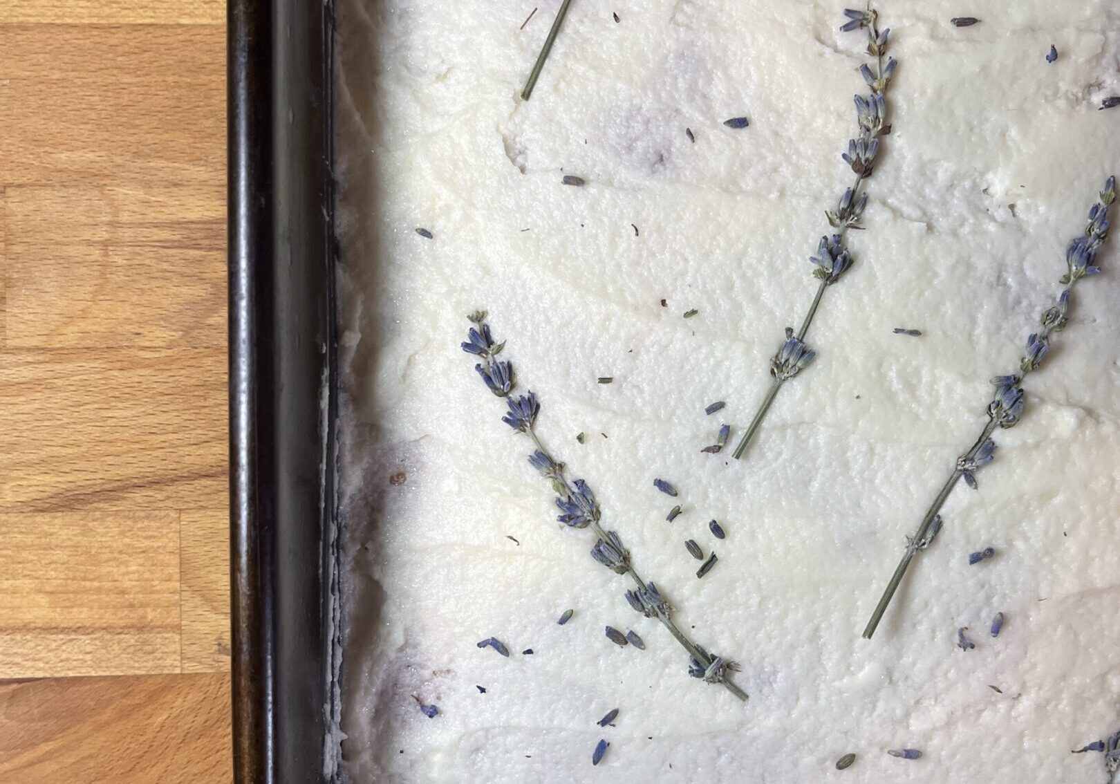 Cake with lavender on white frosting.