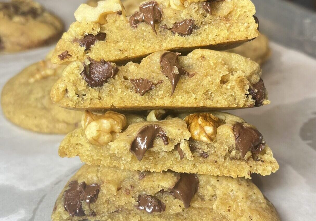 Stacked chocolate chip cookies with walnuts.