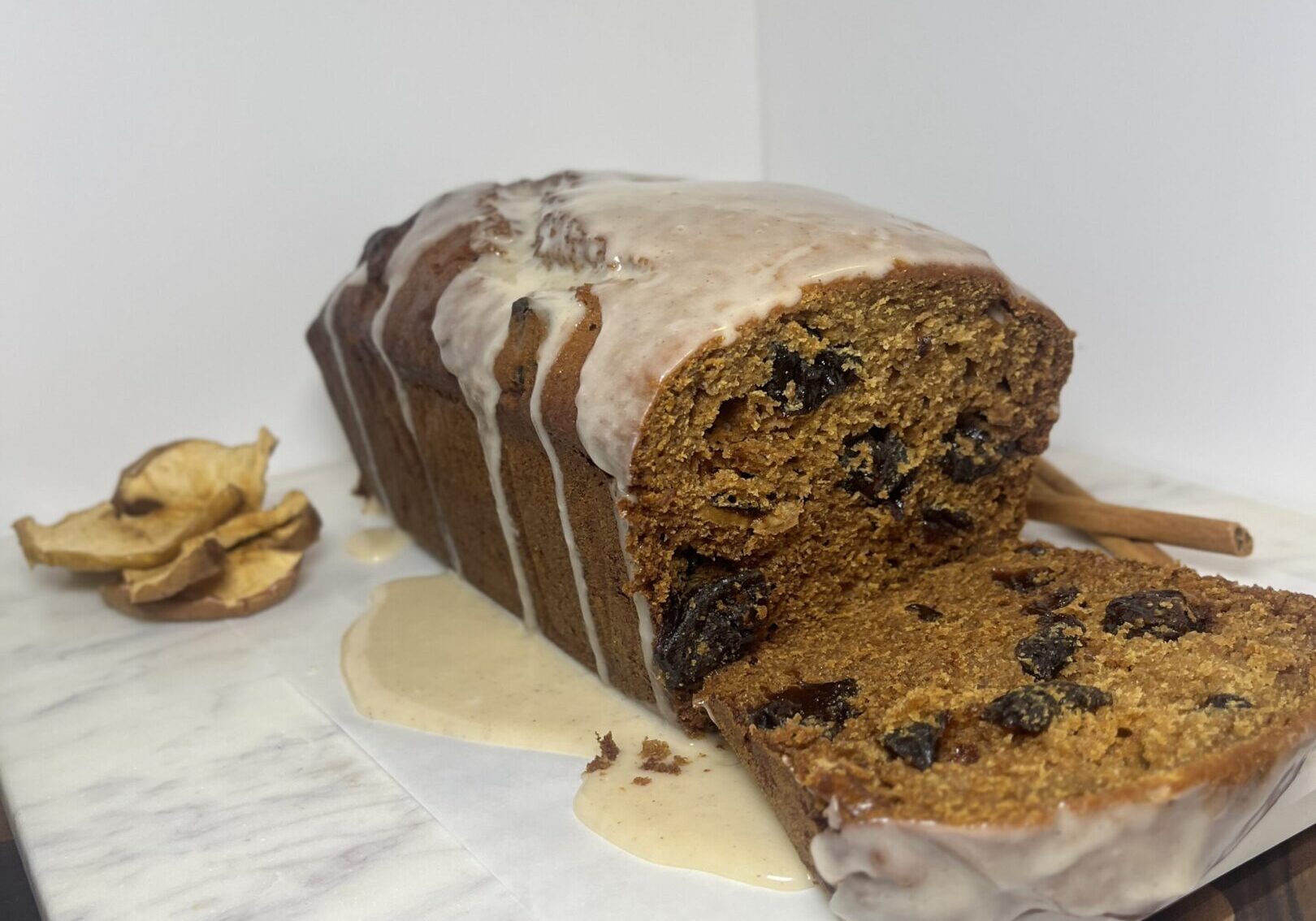 Iced fruit loaf on marble slab.