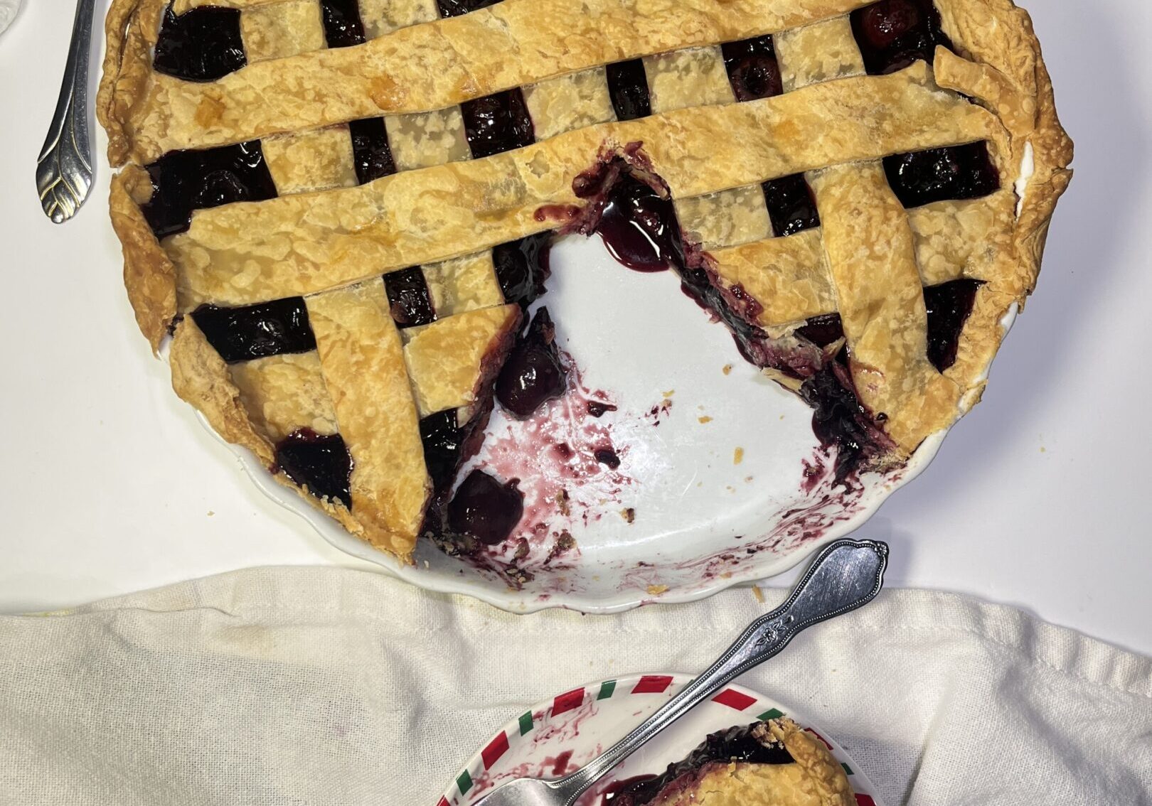 Cherry pie with lattice crust and slice.