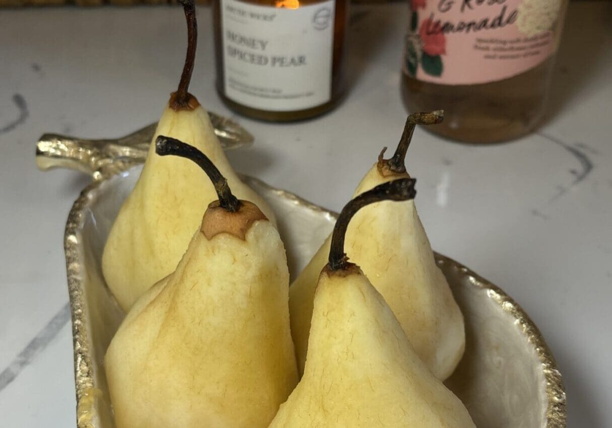 Pears in a decorative dish on counter.